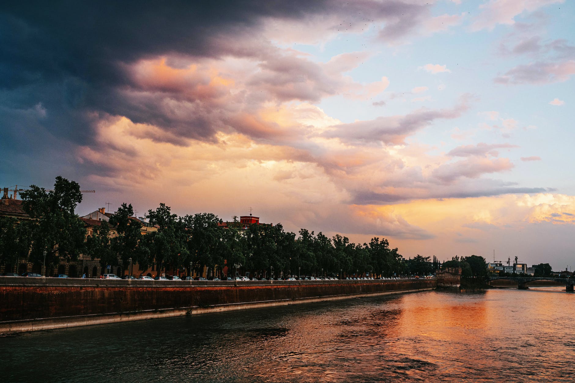 dramatic sky at sunset over city river