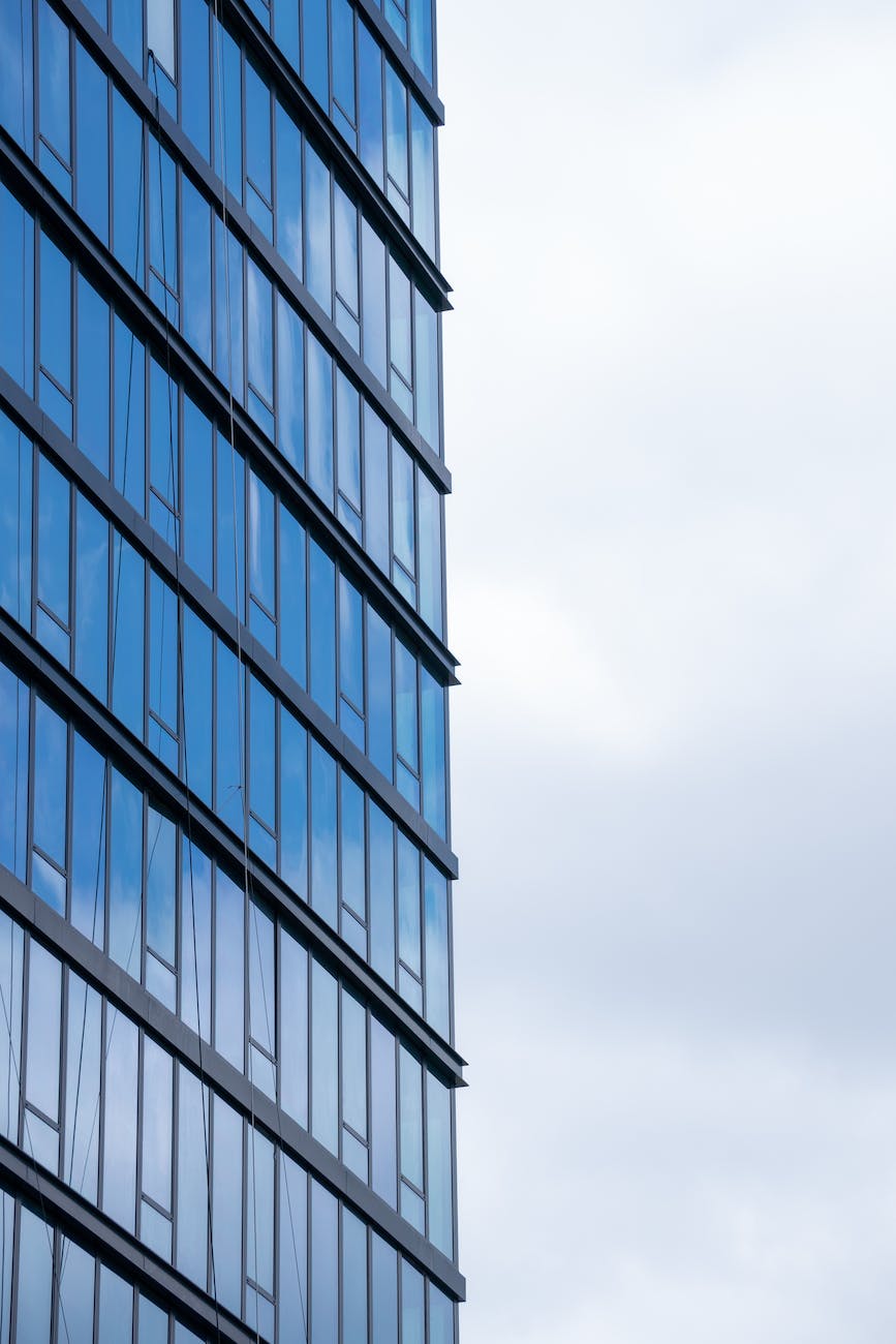 sky reflecting in the windows of a modern glass building